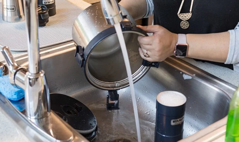 How do I clean stainless steel containers properly?